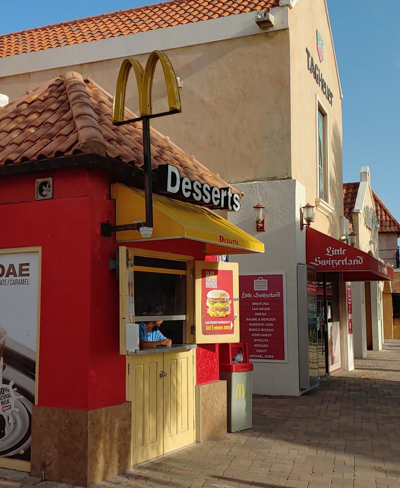 Close-up of a small McDonald&#x27;s that looks like a stand, with a sign that says, &quot;Desserts&quot;