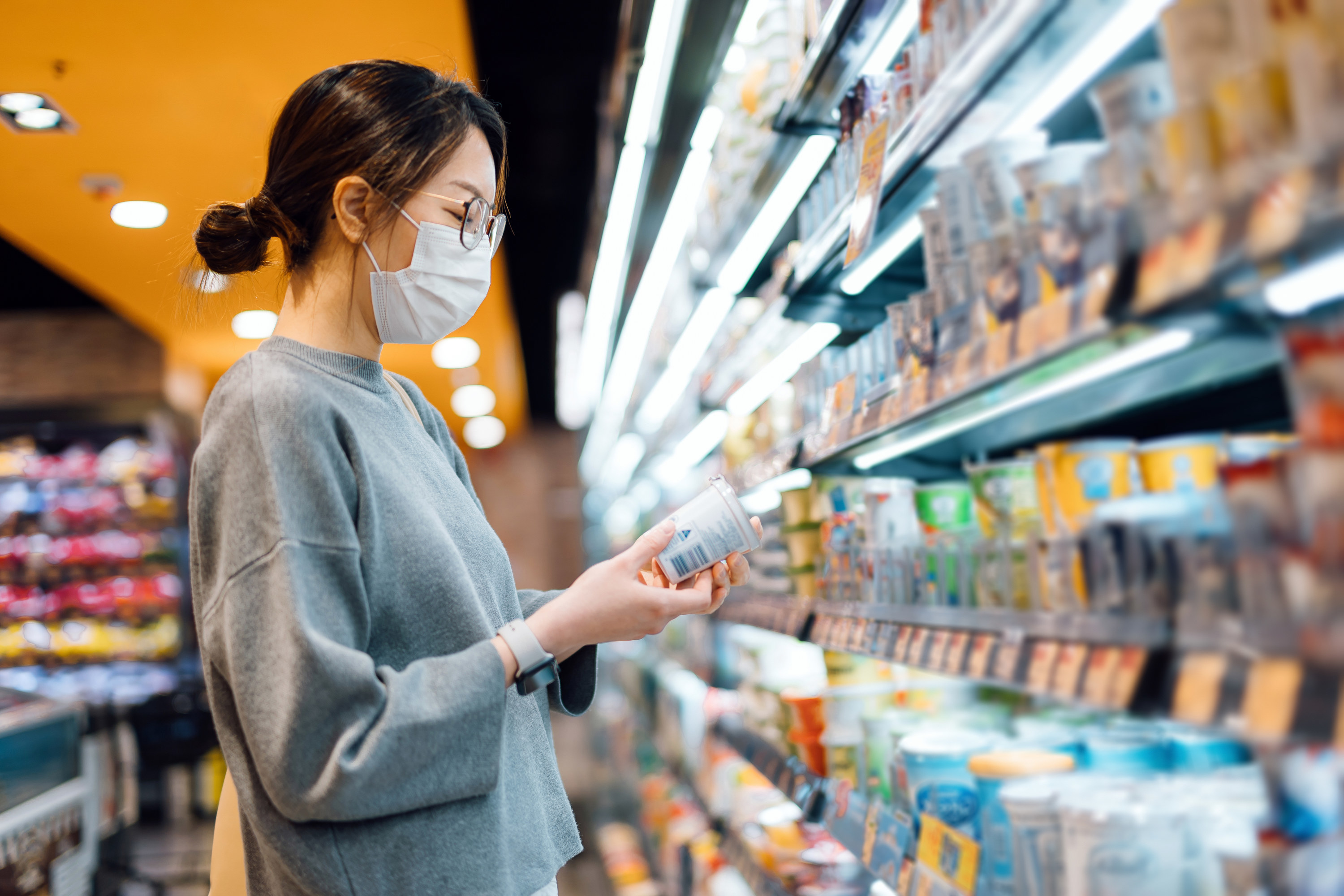 Woman looking at an item at the grocery store