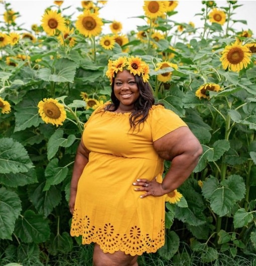 A reviewer wearing the same off shoulder scalloped hem dress in yellow