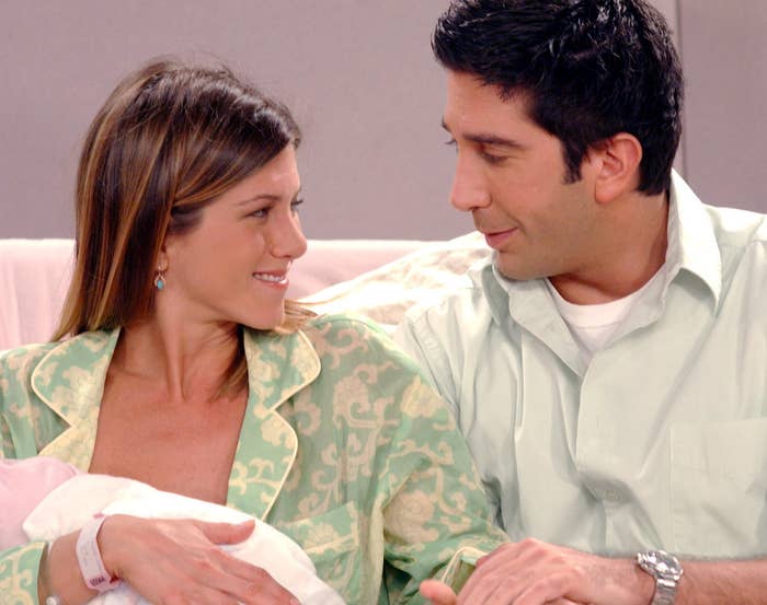 A couple hold a newborn baby in the hospital