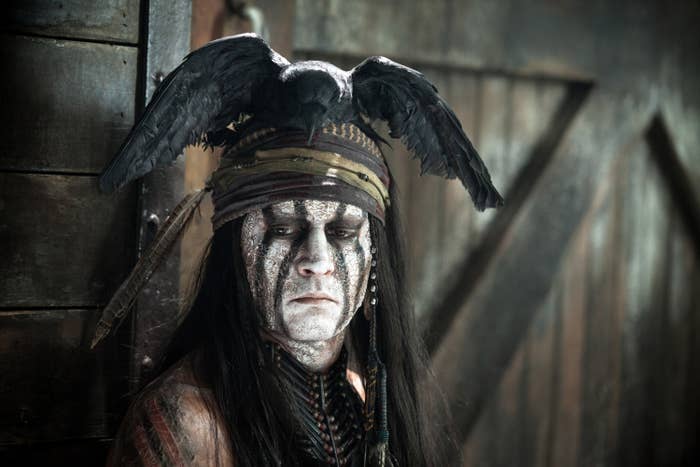 Johnny Depp in &quot;The Lone Ranger&quot; wearing face paint and a fake bird as a hat