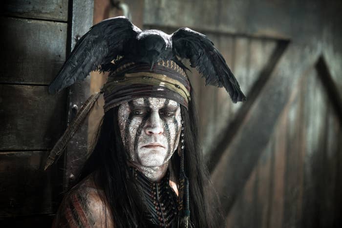 Johnny Depp in "The Lone Ranger" wearing face paint and a fake bird as a hat