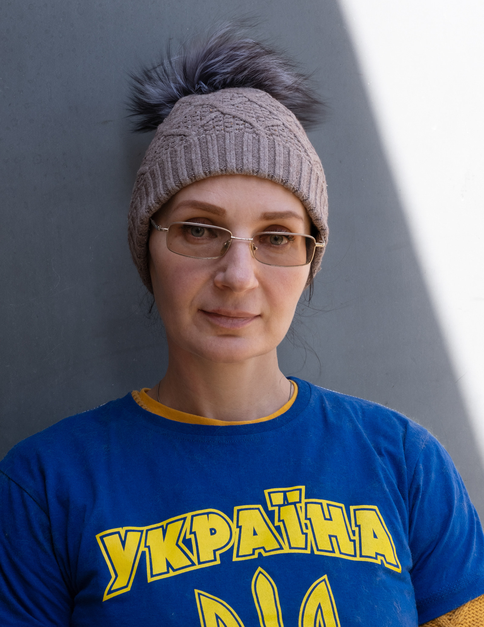 A portrait of a woman wearing a shirt that reads &quot;Ukraine&quot;