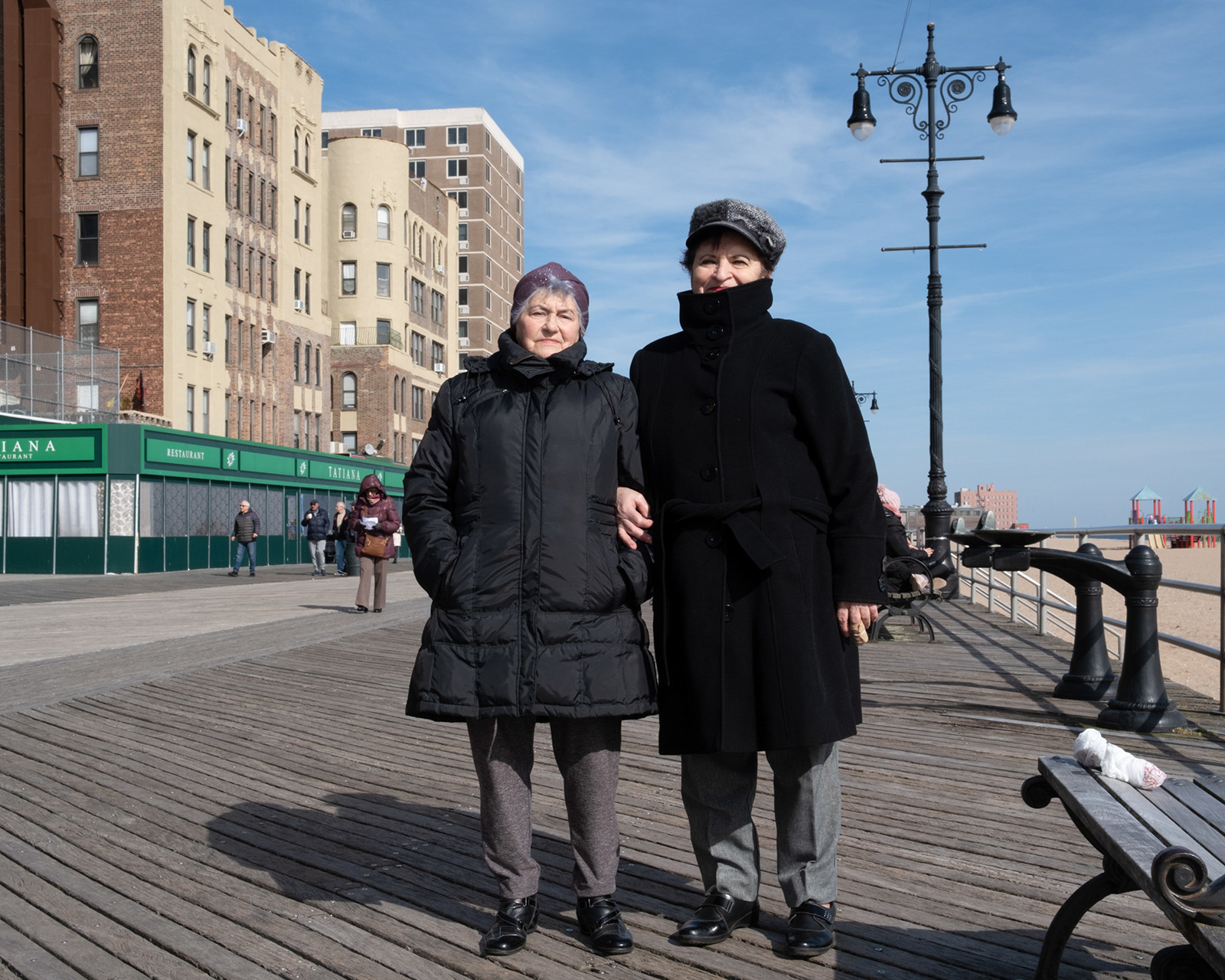 Two older women stand on the boardwalk