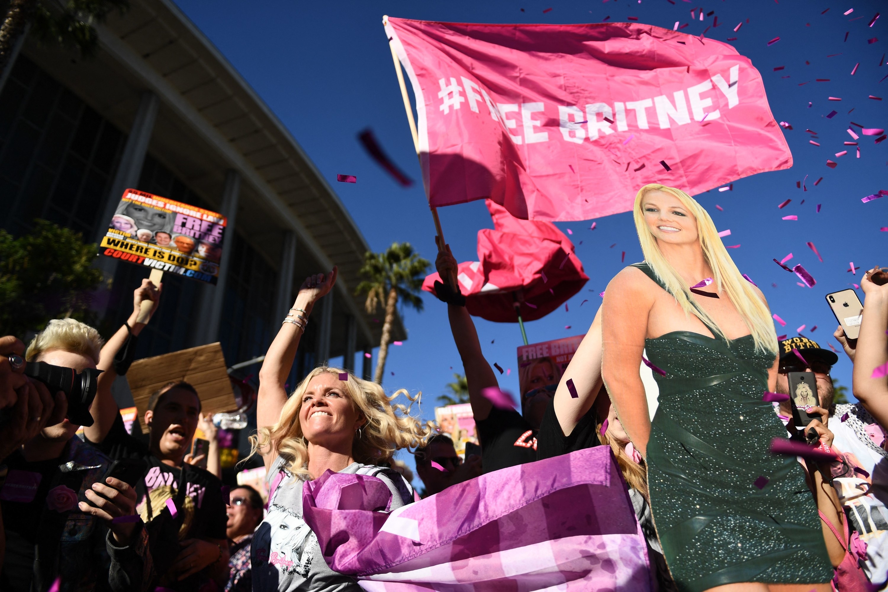 Supporters of the #FreeBritney movement hold signs and cardboard cutouts of Britney outside the courthouse