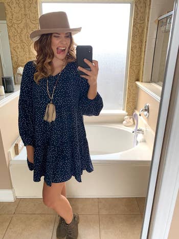 reviewer wearing the dress in polka dot navy