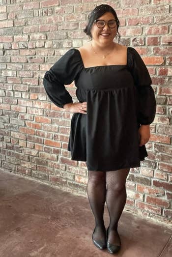 a reviewer wearing the dress in black