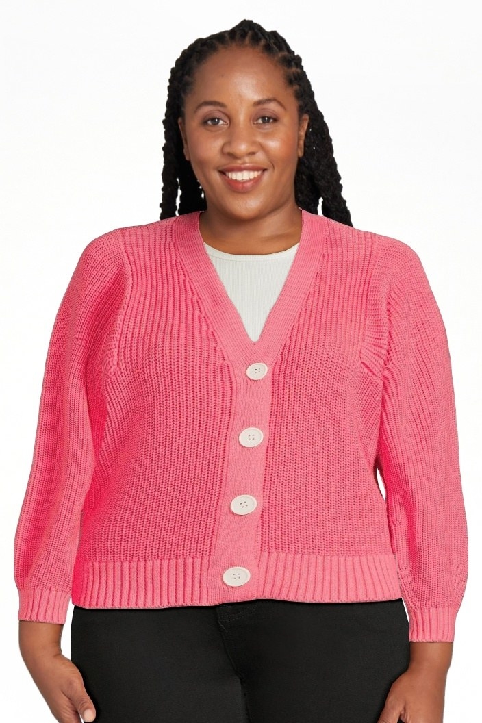 A model wearing a pink boxy cardigan sweater