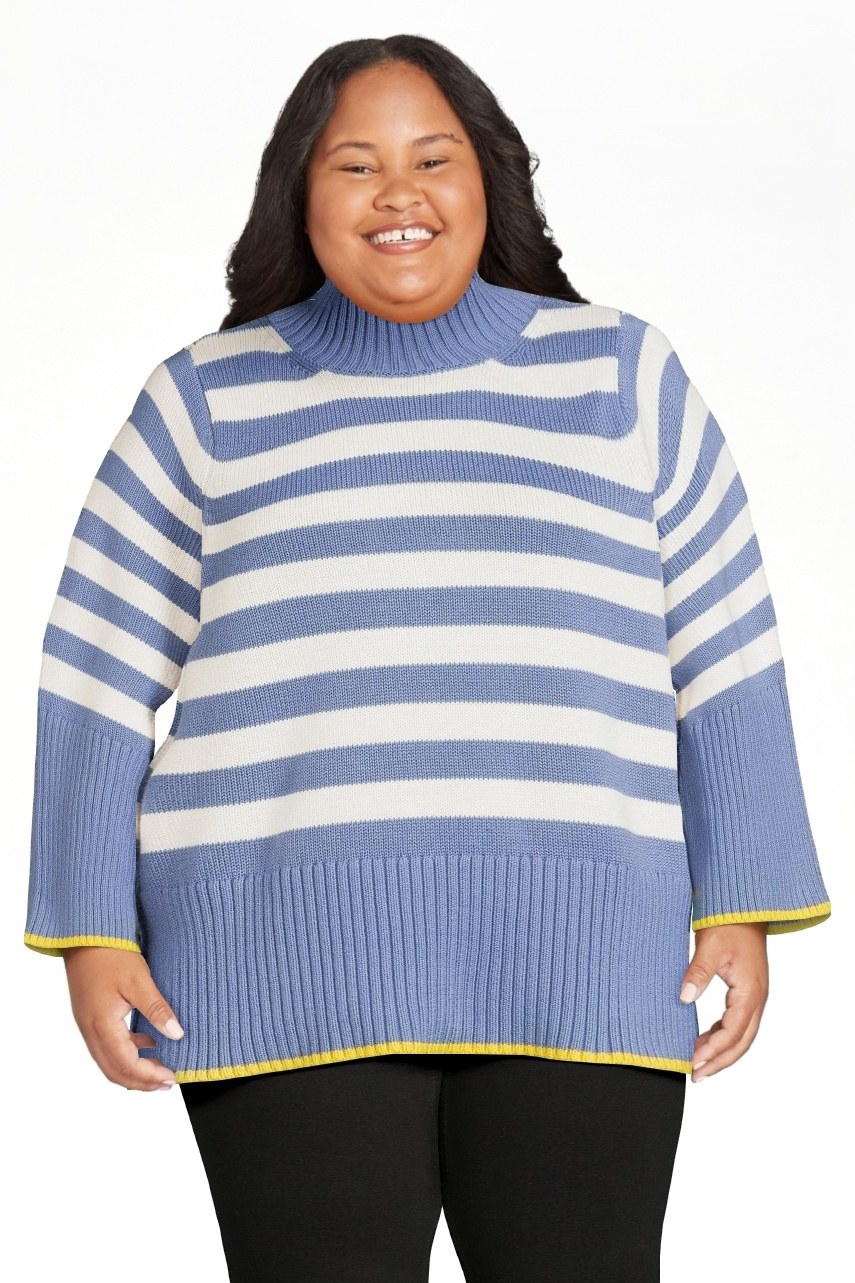 model wearing the blue and white striped sweater with yellow trim