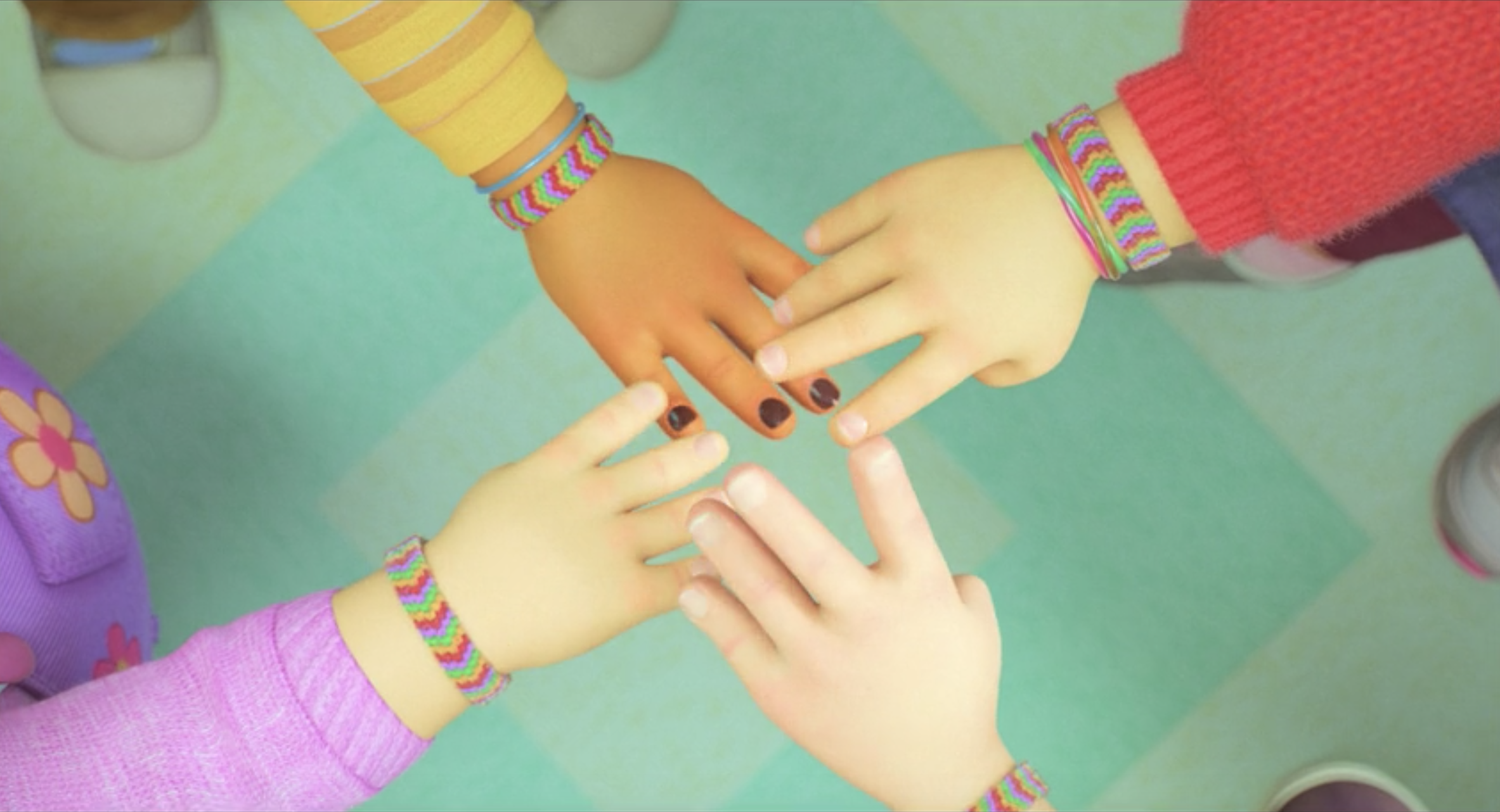 The characters&#x27; hands touching, showing their matching friendship bracelets