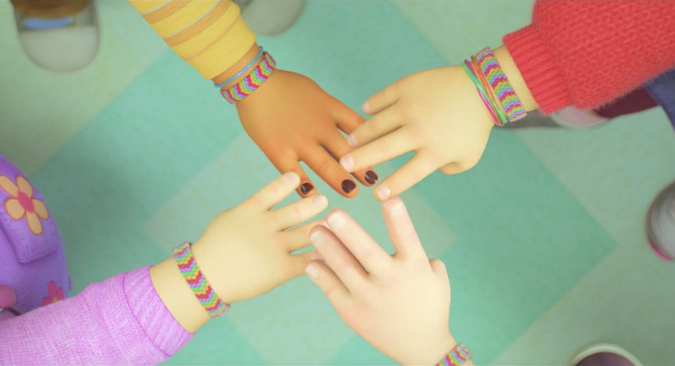 The characters' hands touching, showing their matching friendship bracelets