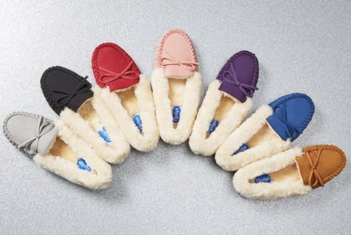 Seven different colored moccasins laid on in an arch