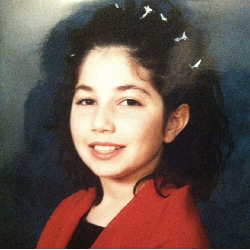 A portrait of the author wearing butterfly clips in her hair