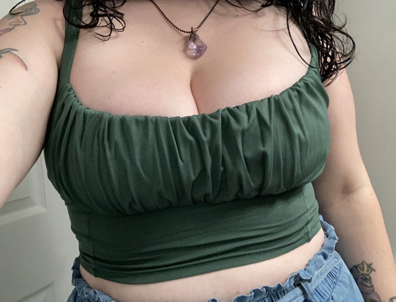 a reviewer wearing the top in dark green