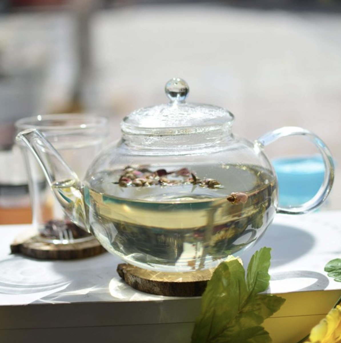 The glass teapot with loose leaf tea brewing