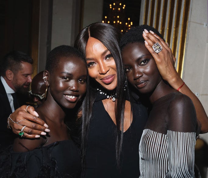 Naomi Campbell posing with Adut Akech and Anok Yai backstage at a fashion show