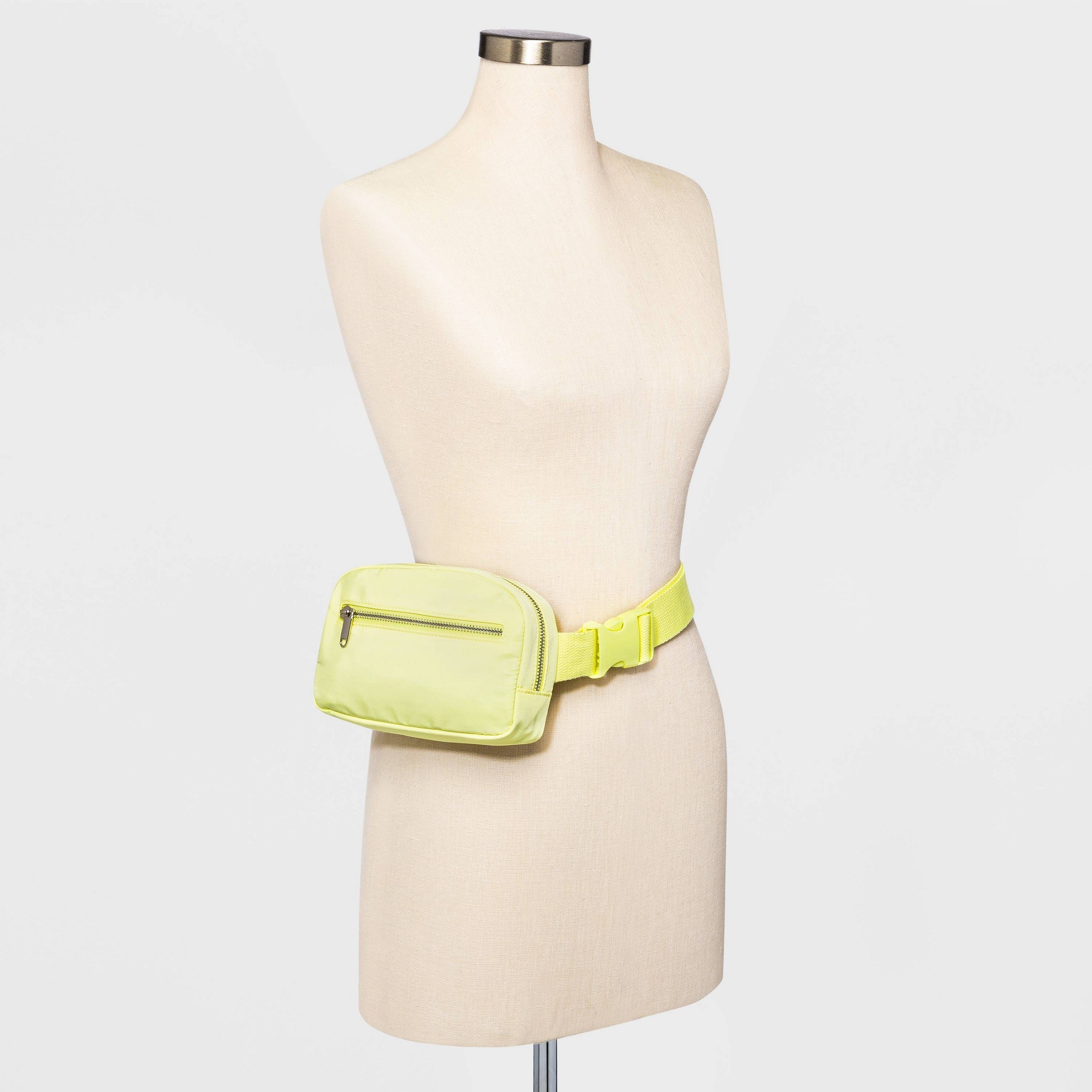 the fanny pack in yellow on a mannequin