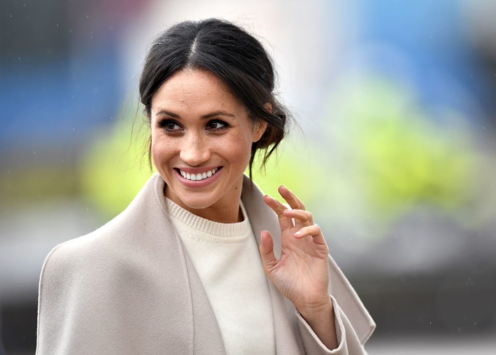 A candid photo of Meghan Markle waving to the public