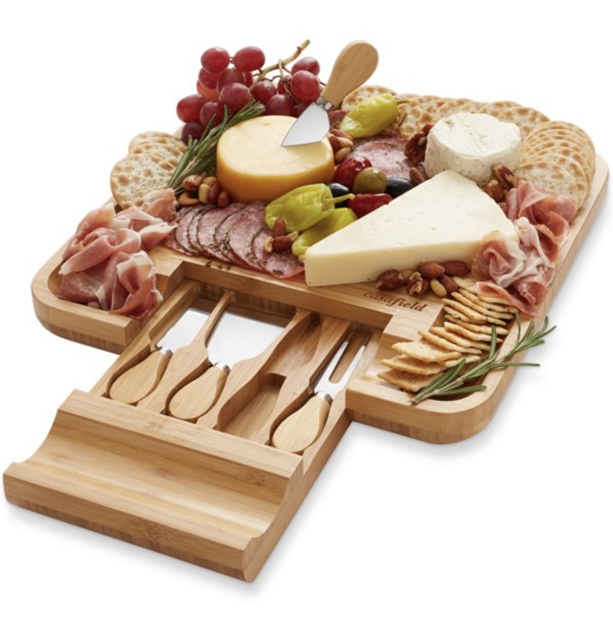 The bamboo serving tray filled with crackers, meats, and fruit