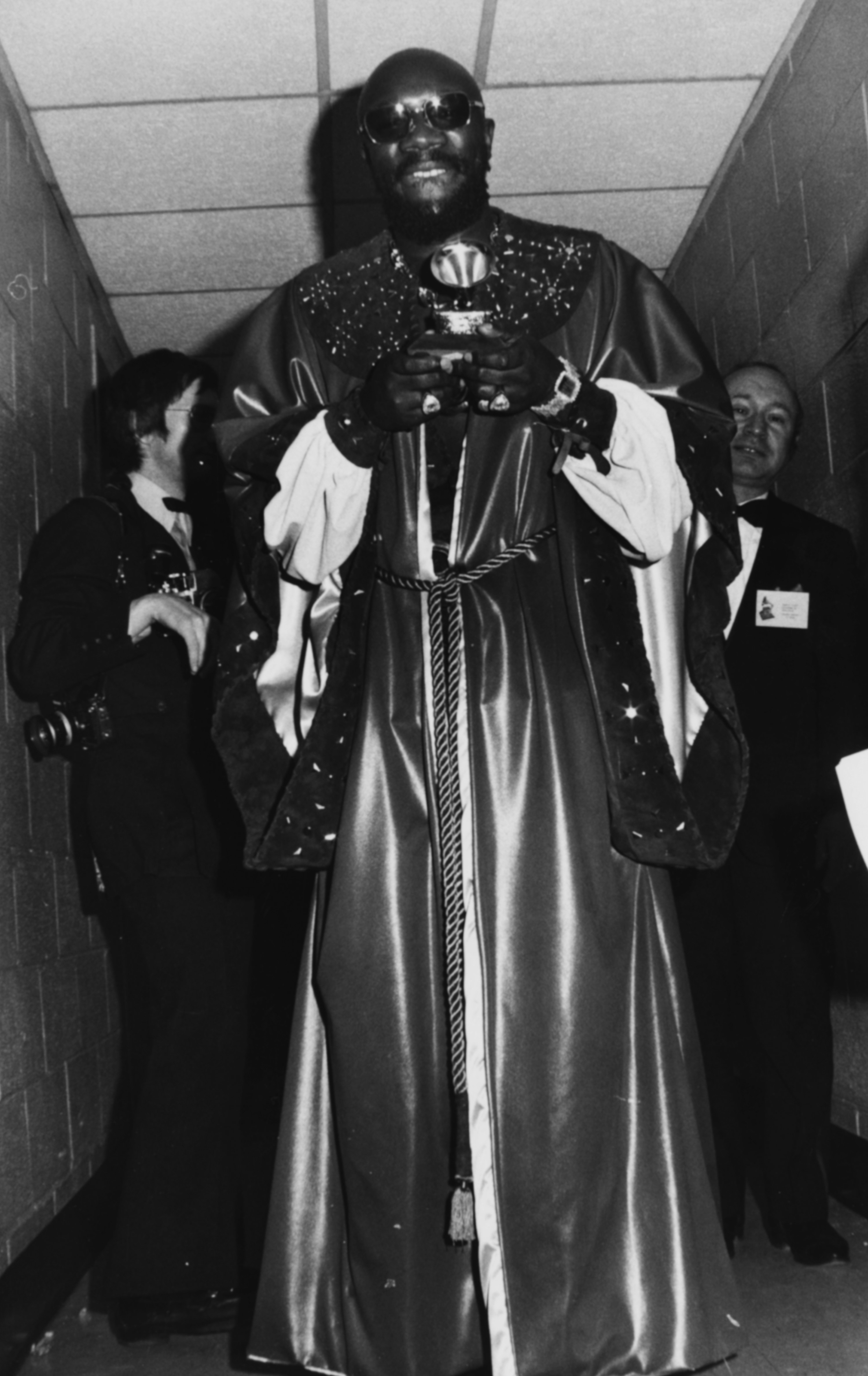 Actor and singer Isaac Hayes wearing a long robe and holding his Grammy in 1972