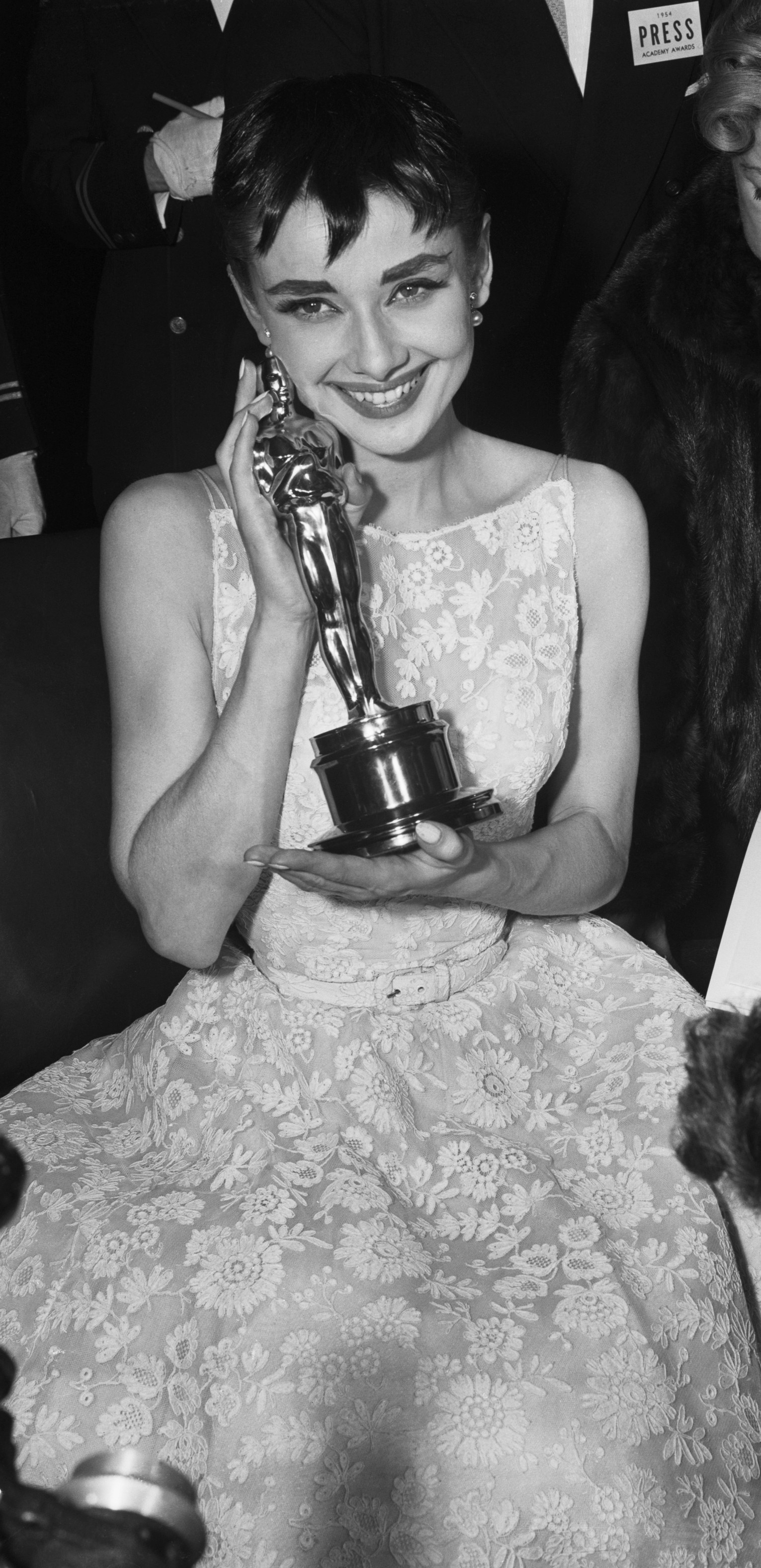 Hepburn posing with her Oscar backstage