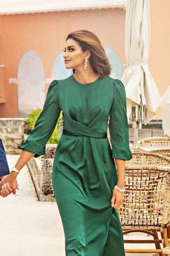a reviewer wearing the green dress for a photoshoot