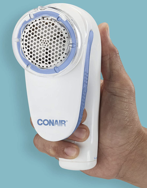 Someone holding up the Conair fabric shaver