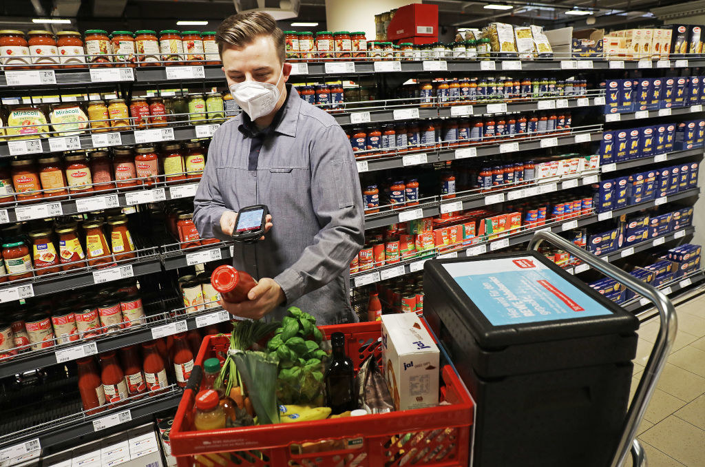 A Rewe employee assembles ordered products for the pick-up service in a supermarket
