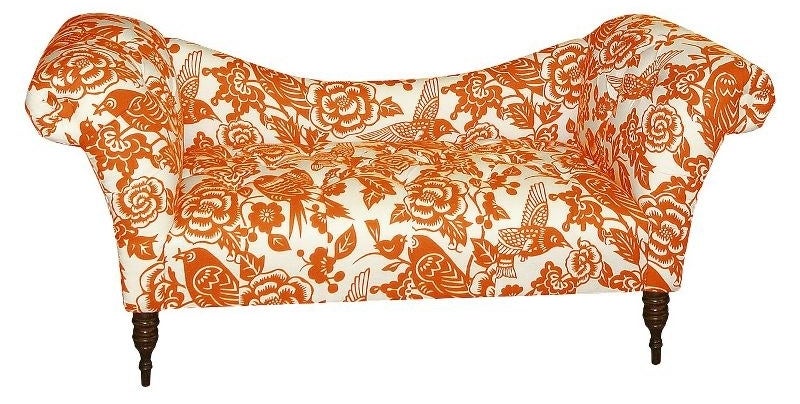 an upholstered tufted rolled arm chaise in orange and white
