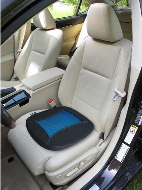 Blue and black seat cushion on beige car seat