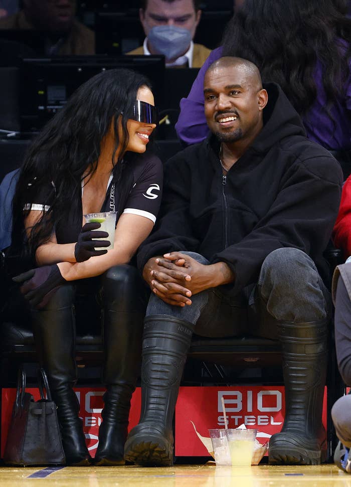 Chaney and Ye sitting courtside at a basketball game