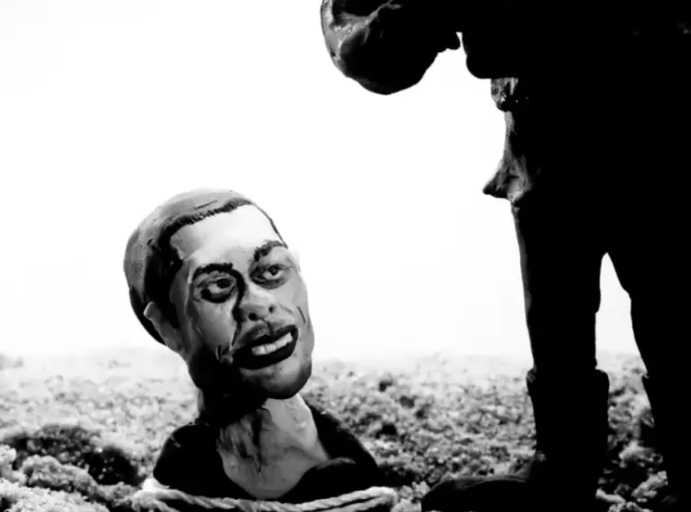 Footage from the video shows a clay figure of Pete Davidson buried up to his neck