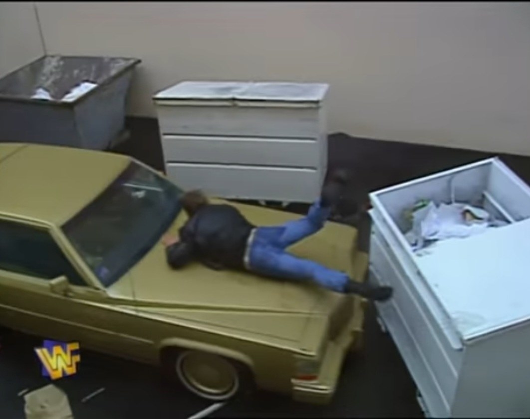 Roddy Piper leaps onto a golden car in his Hollywood Backlot Brawl at Wrestlemania 12