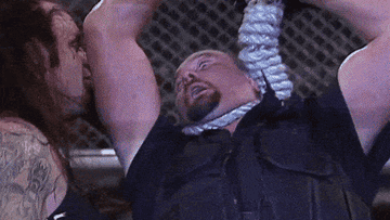 The Undertaker hangs The Big Boss Man from a Hell in a Cell cage at Wrestlemania 15