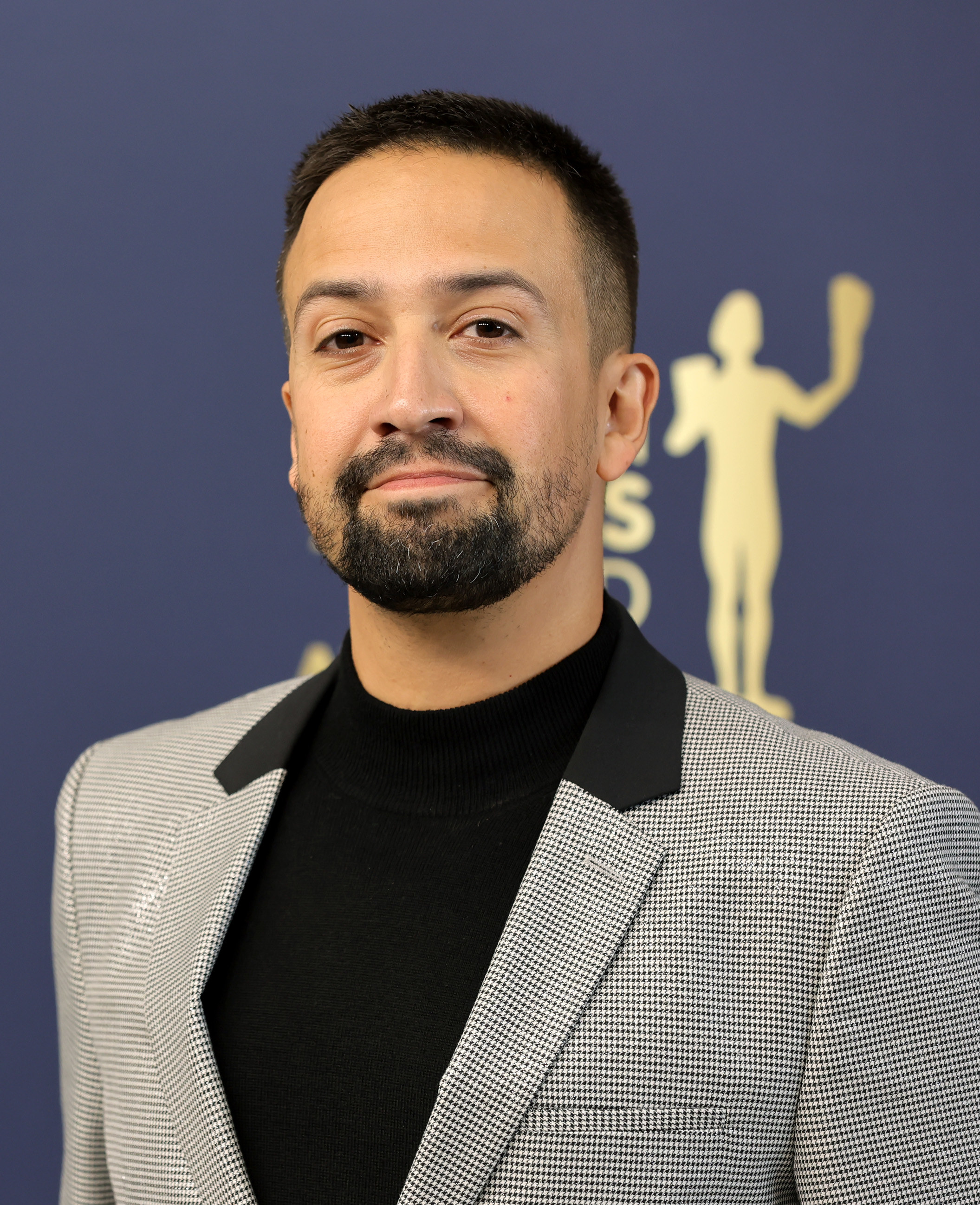 Lin-Manuel Miranda poses at the Screen Actors Guild Awards in February 2022