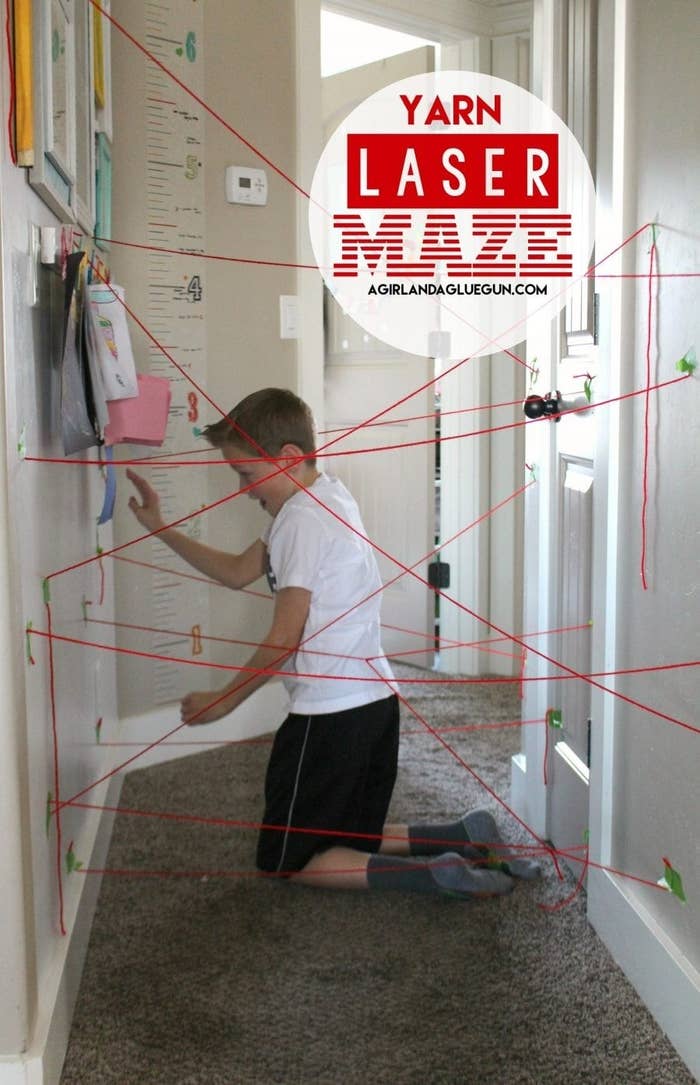 Blogger&#x27;s photo of their child trying to maneuver through the red strings attached to the walls