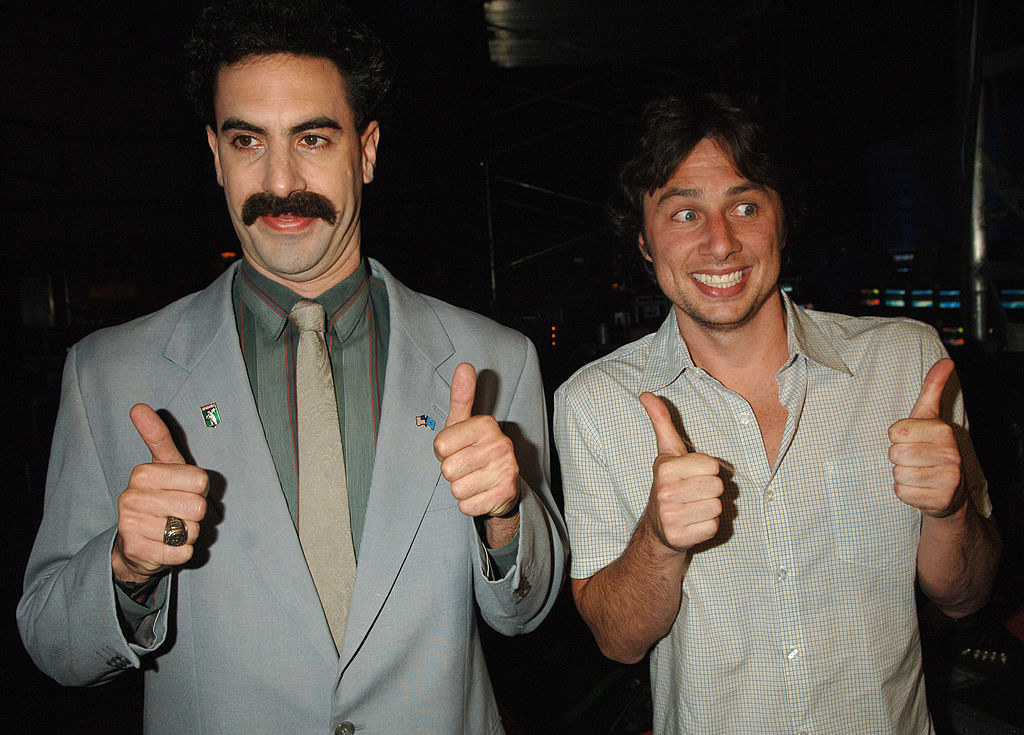 Borat with his thumbs up and Zach with his thumbs up