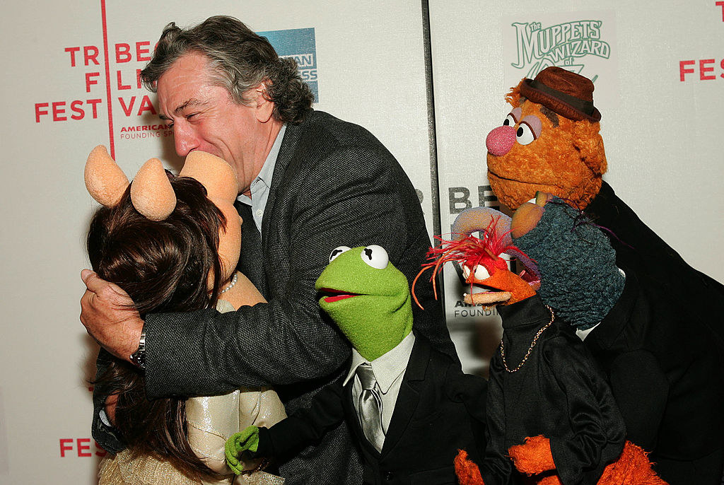 Robert kissing miss piggy as kermit, gonzo, pepe, and fozzie look on