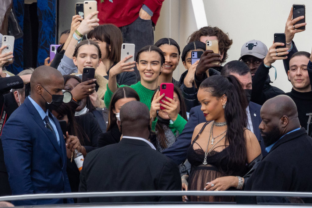Rihanna in a crowd of people trying to take her photo