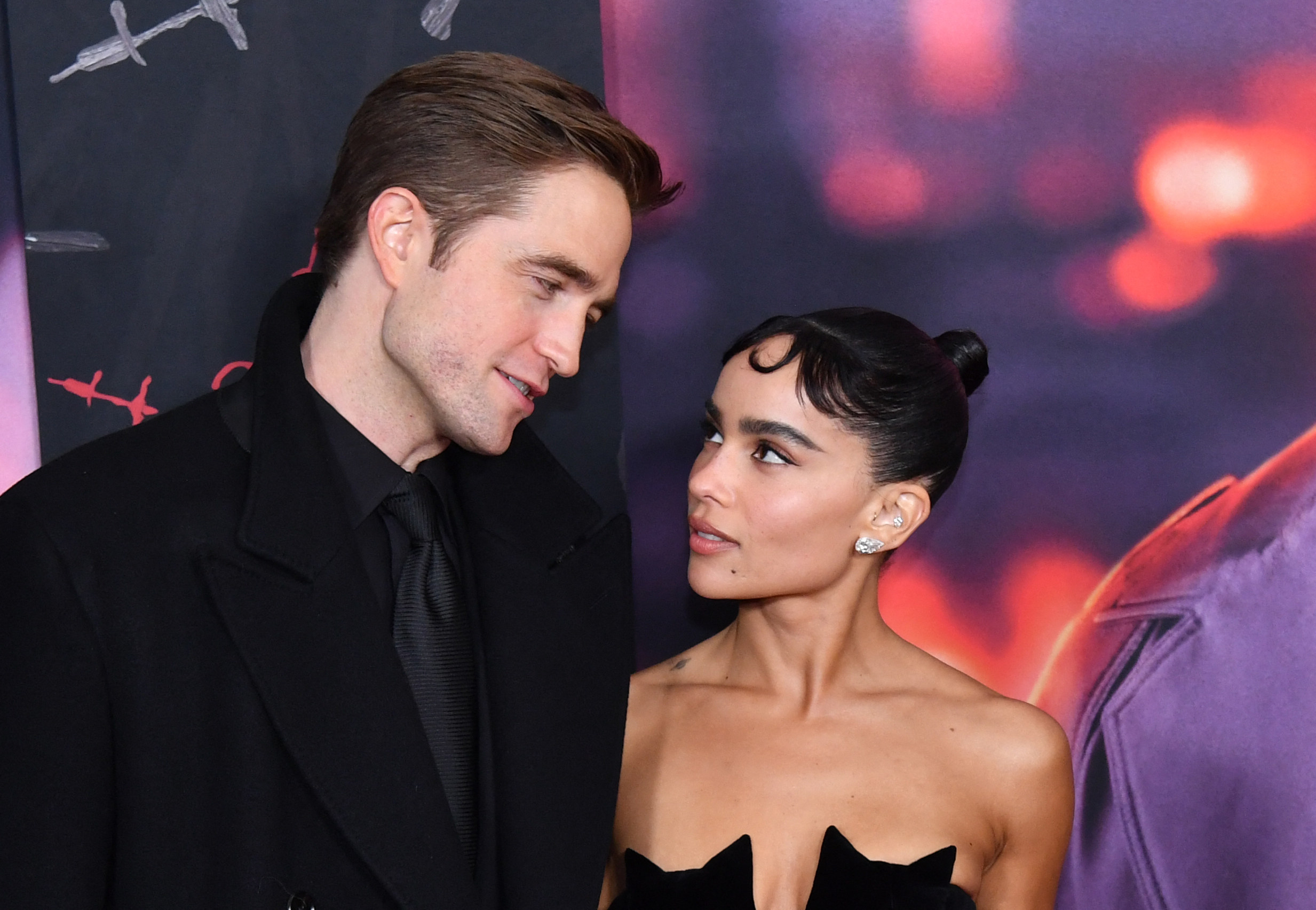 Zoe Kravitz and Robert Pattinson looking at each other during th Batman premiere