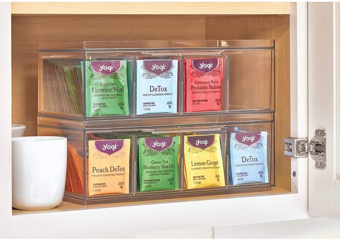 A tea organizer fully stocked in a kitchen cabinet