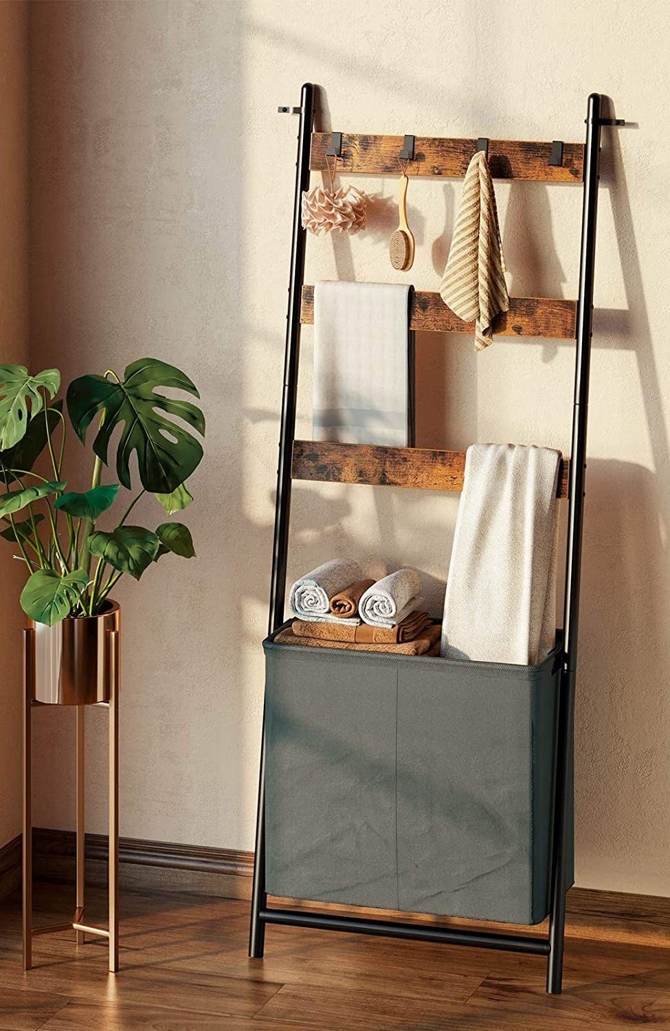 The ladder shelf leaning against a wall, next to a plant