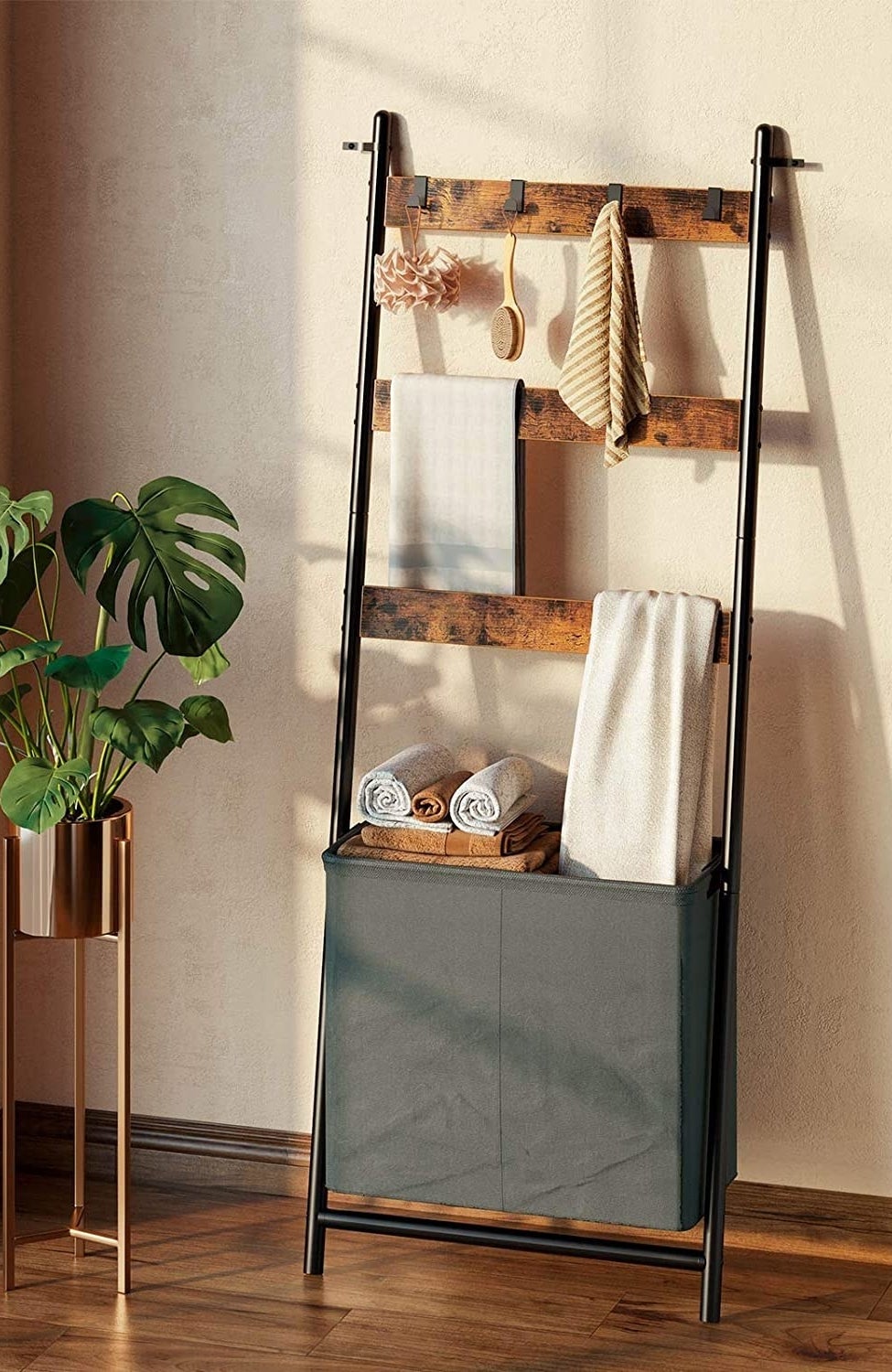 The ladder shelf leaning against a wall, next to a plant