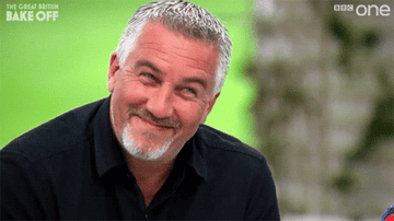 Paul Hollywood from &quot;Great British Baking Show&quot; wagging his finger at a contestant while smiling