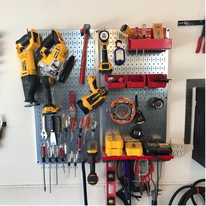 A reviewer&#x27;s image of a utility tool storage and garage peg organizer
