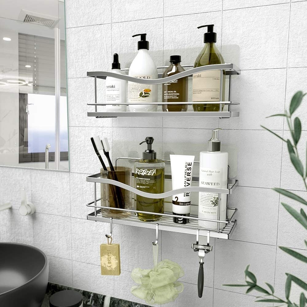The shelves on a bathroom wall with various bath and body products on them
