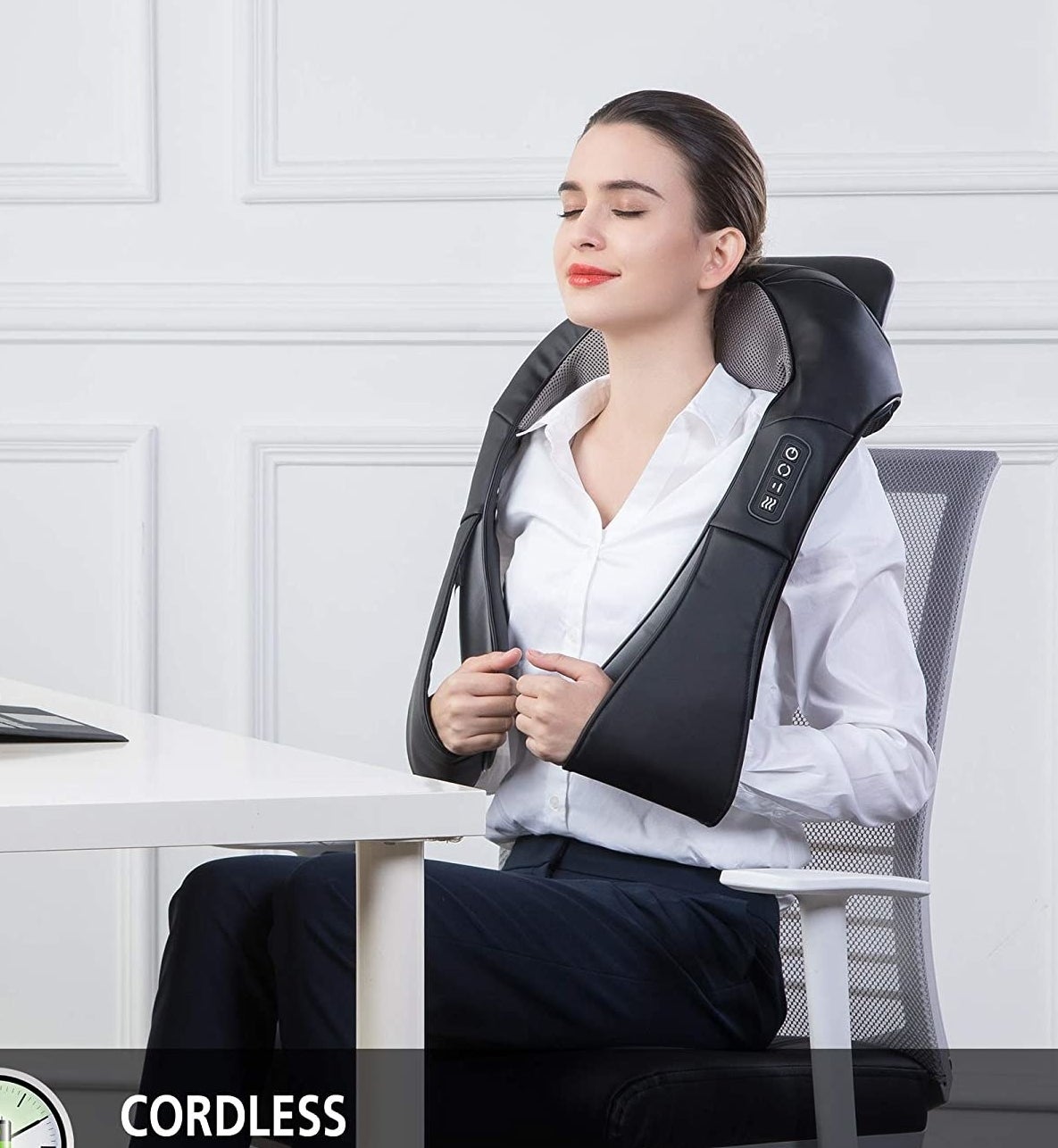 The massager around a person&#x27;s neck as they work at their desk
