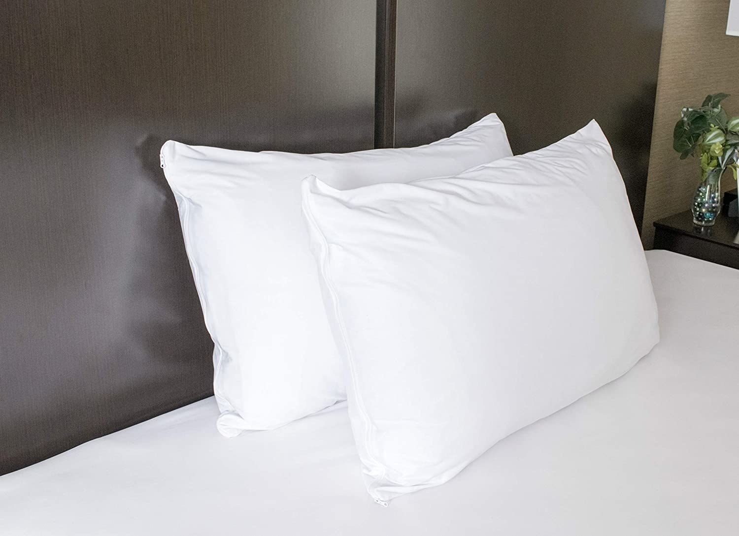two pillows with pillow covers on them