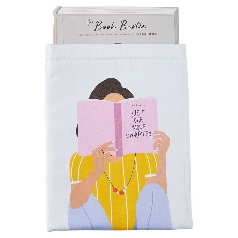 A fabric book holder with an illustration of a person reading a book on the front