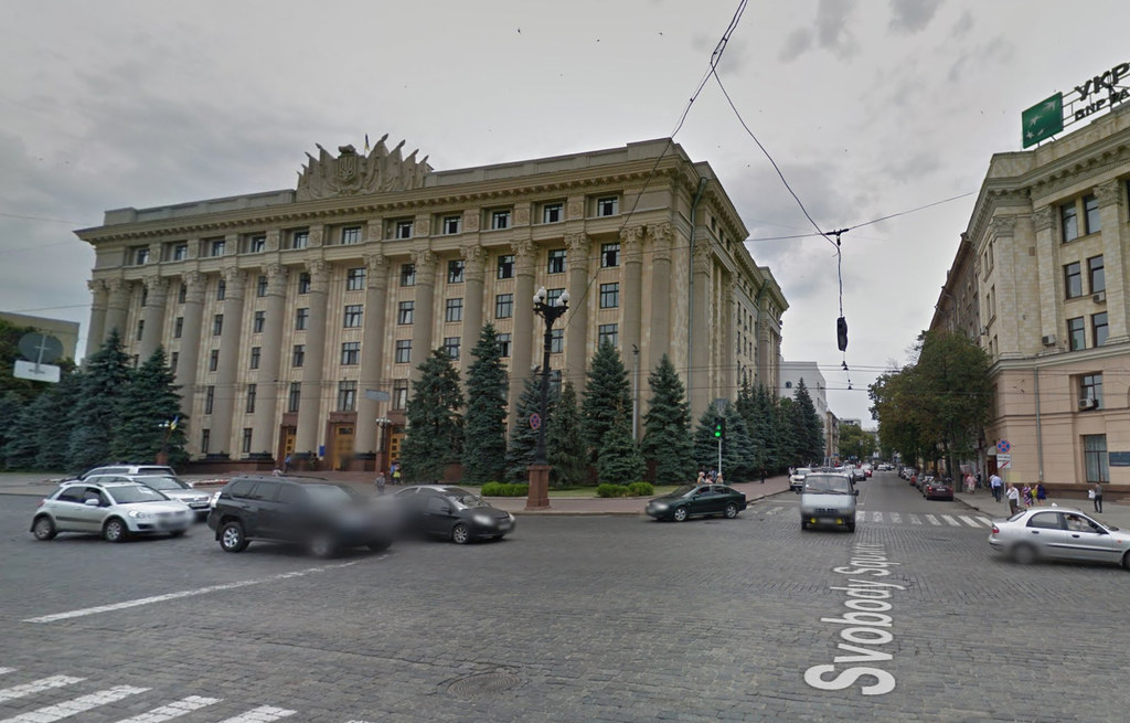 The same building with no damage with cars driving by